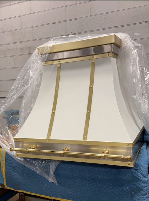 A white and gold hood is wrapped in plastic