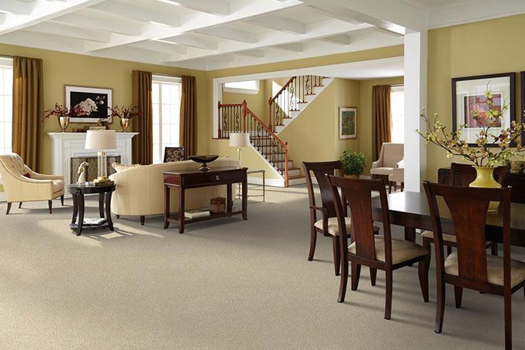 A living room with a dining room table and chairs