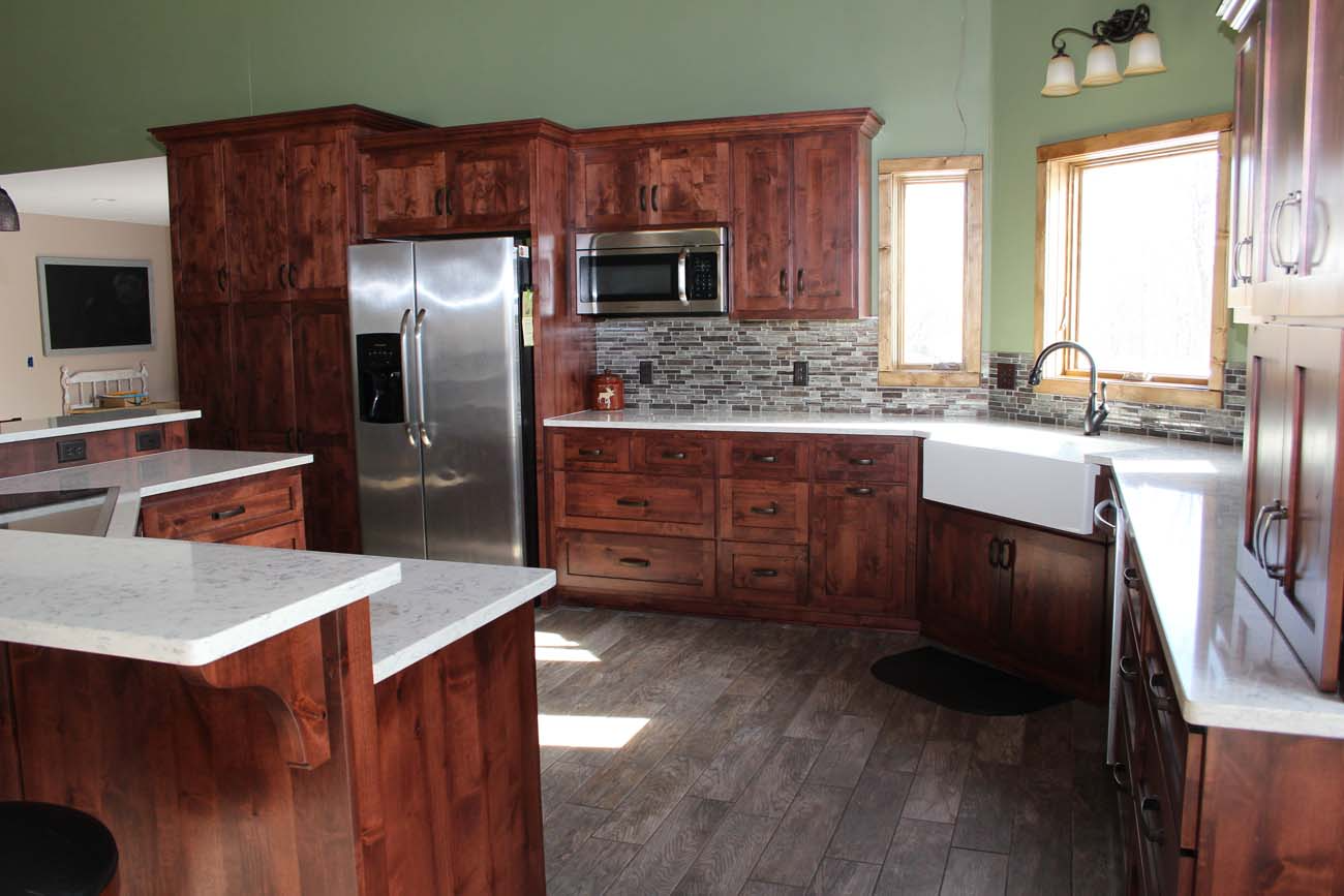 A kitchen with stainless steel appliances and wooden cabinets