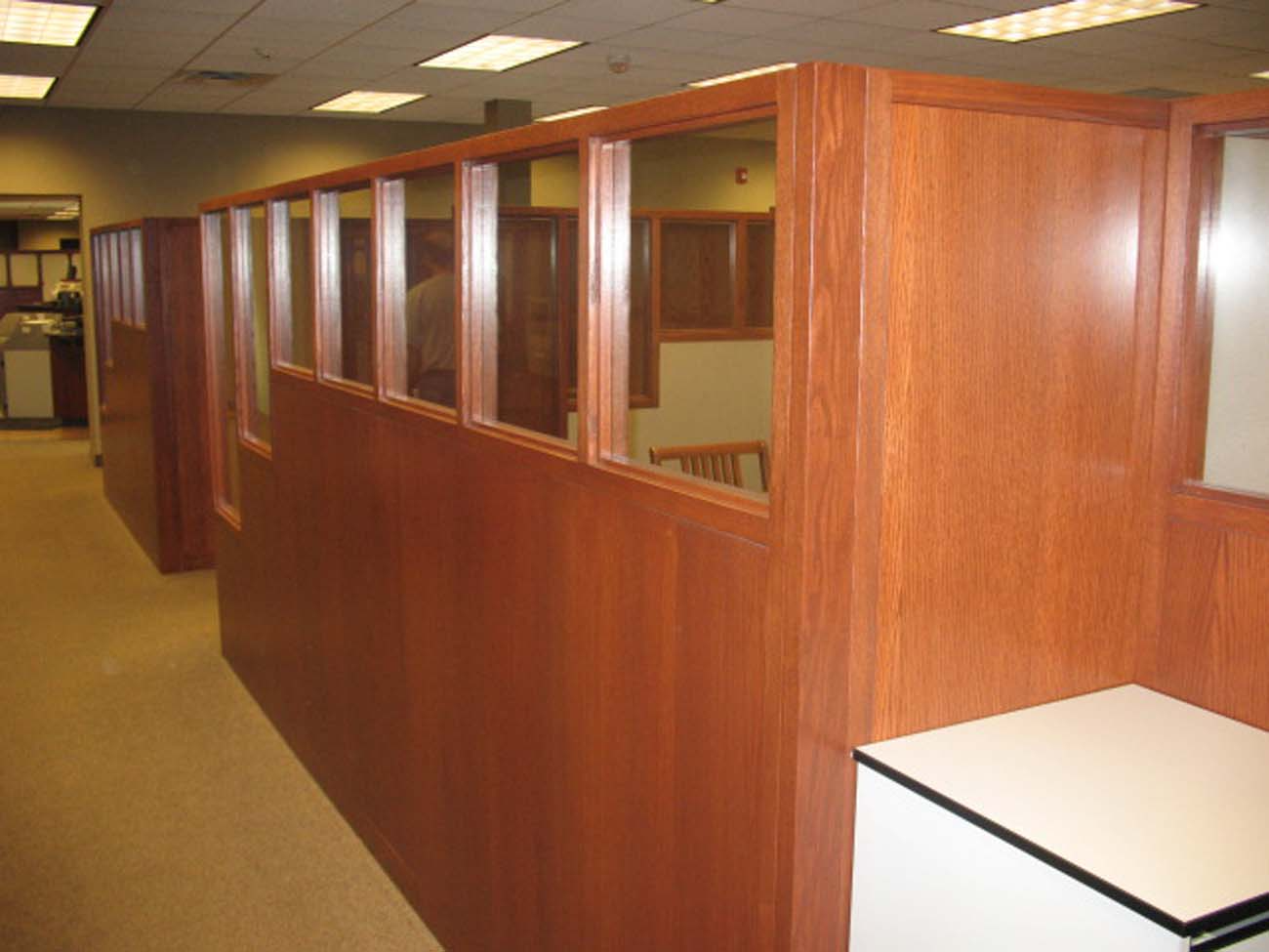A row of wooden cubicles in an office building