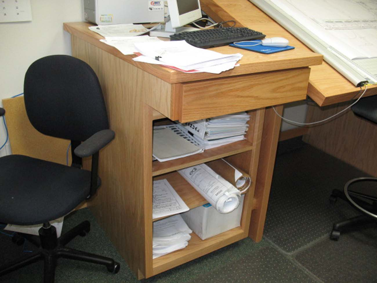 A desk with a chair and a computer on it
