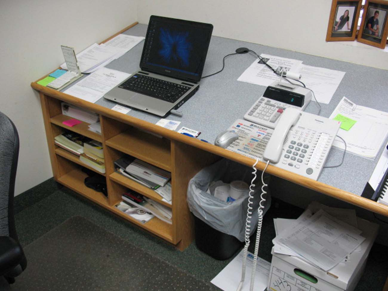 A desk with a laptop and a phone on it