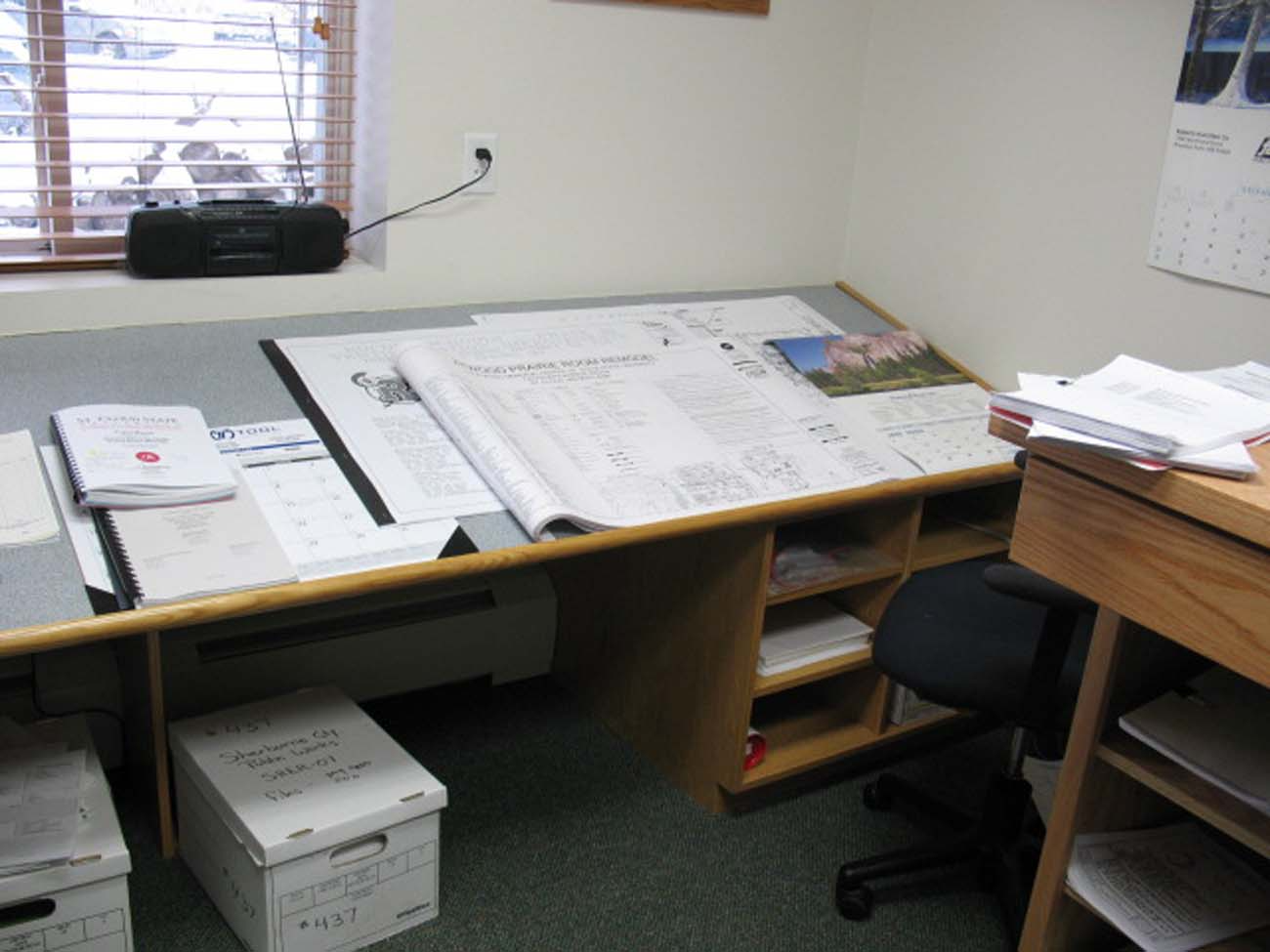 A desk with a lot of papers on it