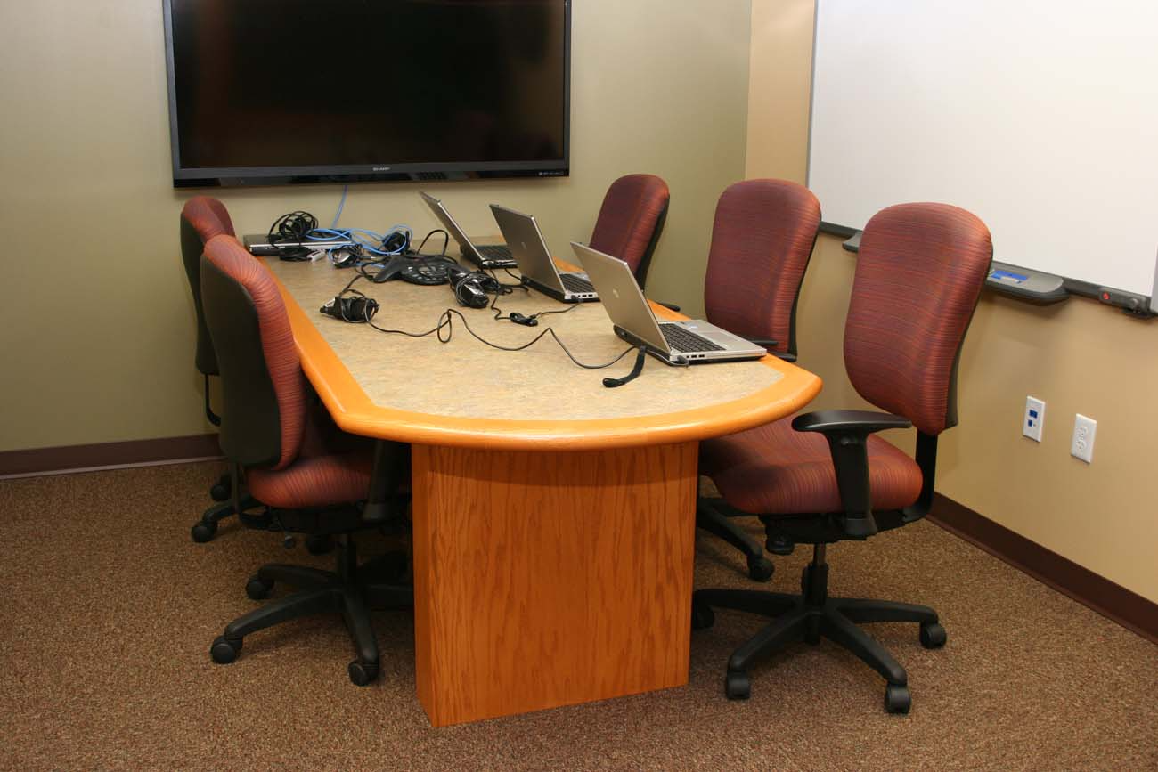A conference room with a long table and chairs