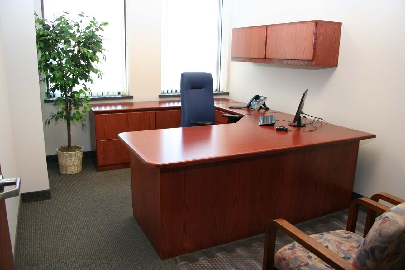 A small office with a large desk and chair