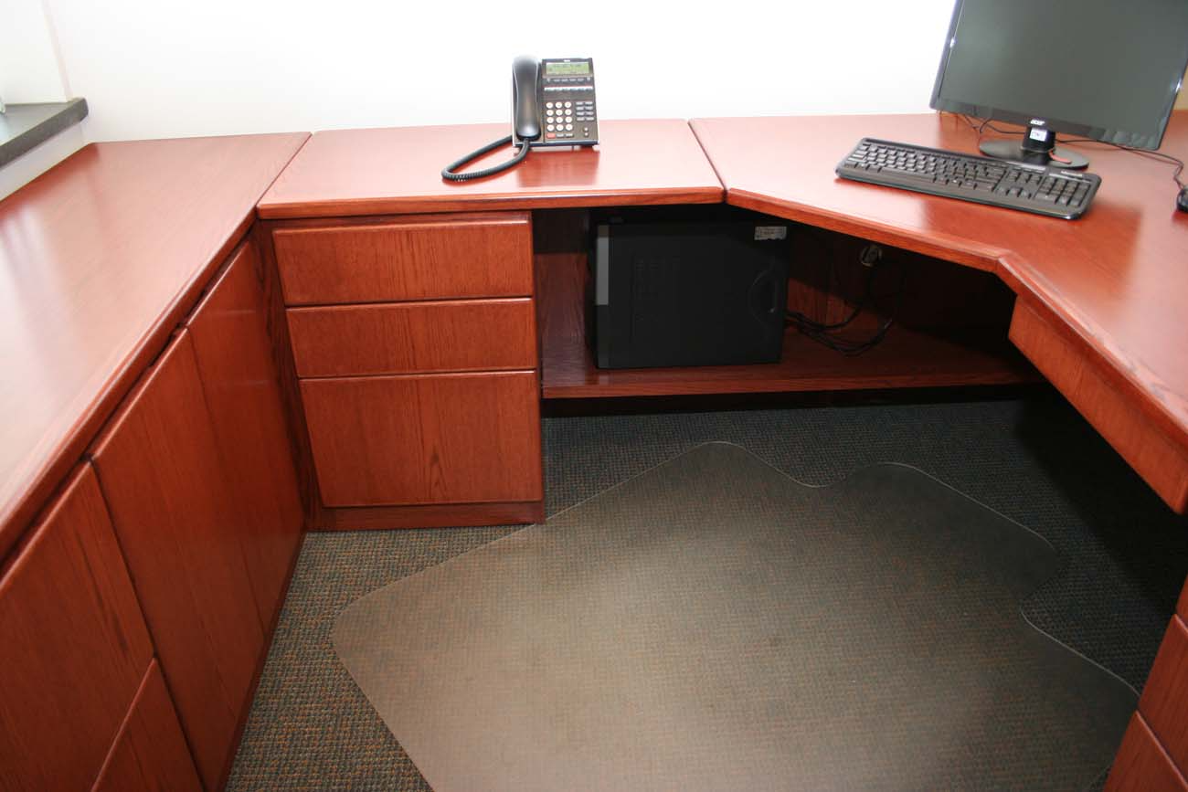 A desk with a computer and a phone on it