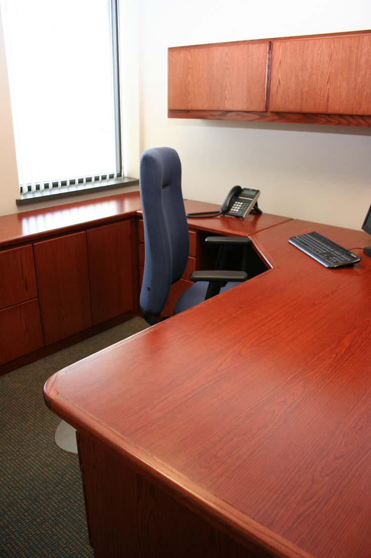 A desk with a chair and a telephone on it