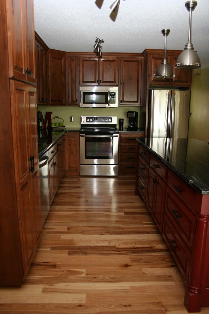 A kitchen with wooden cabinets and stainless steel appliances