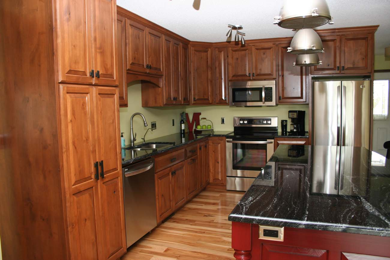 A kitchen with wooden cabinets and stainless steel appliances