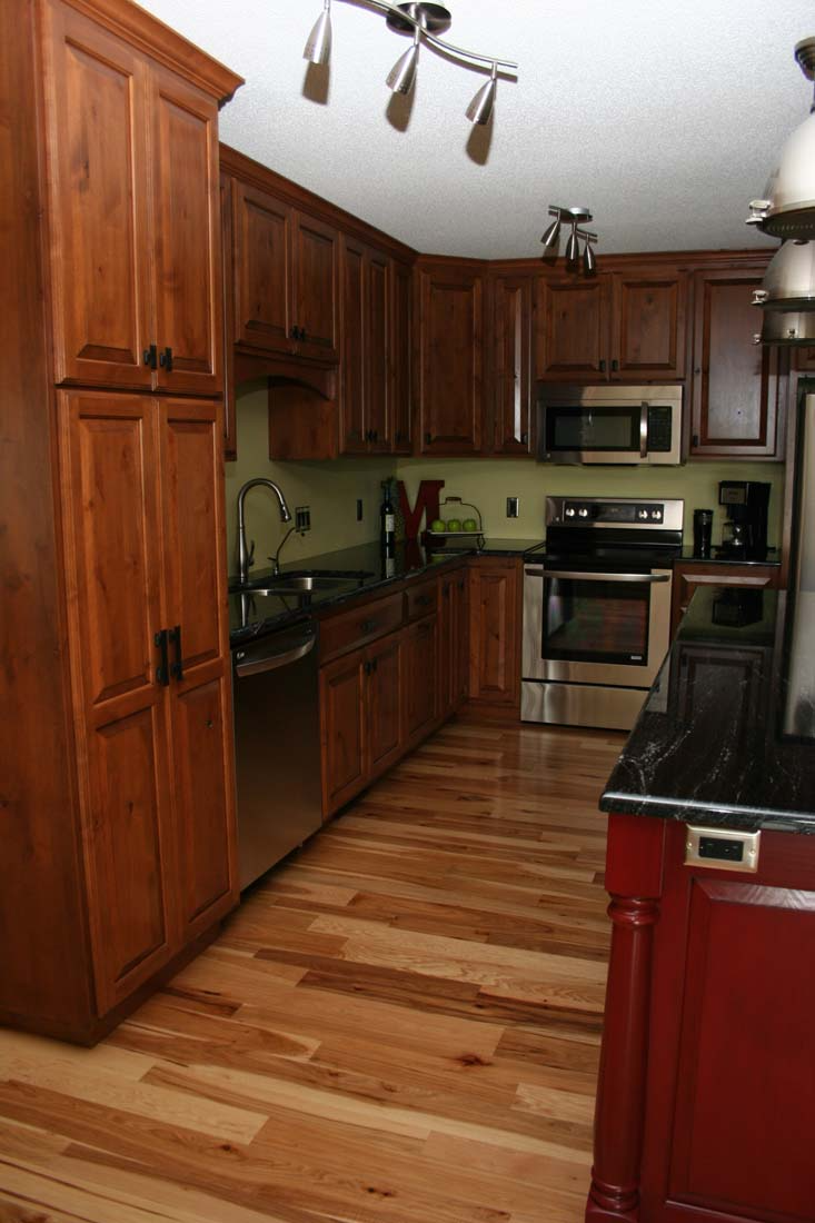 A kitchen with wooden cabinets and stainless steel appliances