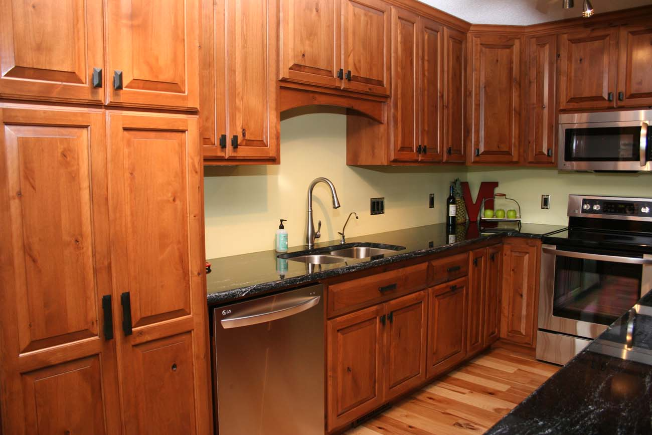 A kitchen with wooden cabinets and stainless steel appliances