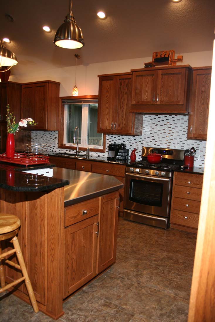 A kitchen with wooden cabinets and stainless steel appliances.