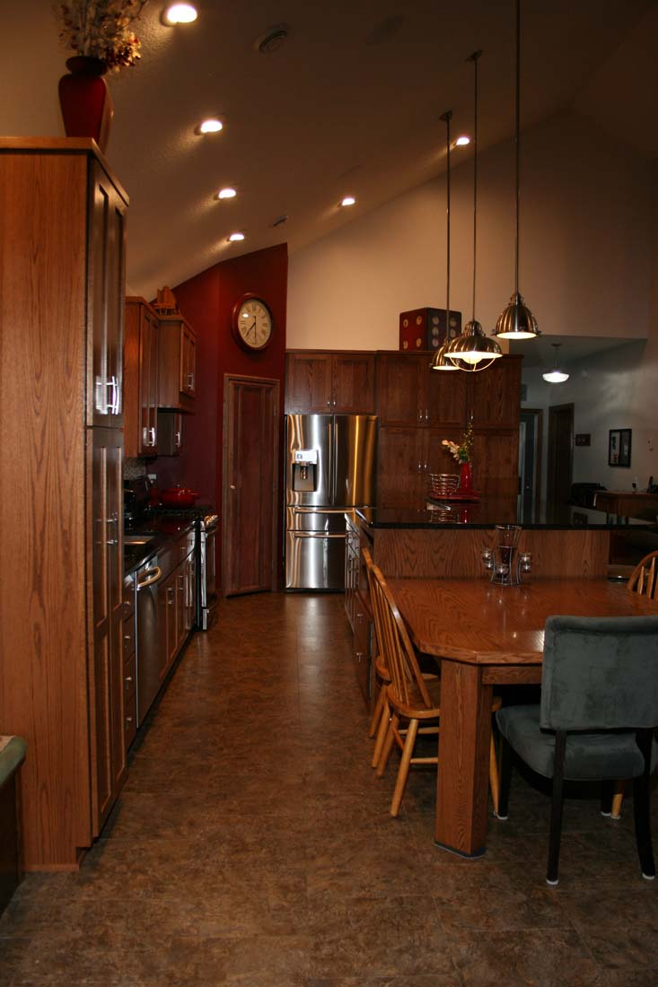 A kitchen with a table and chairs and a refrigerator