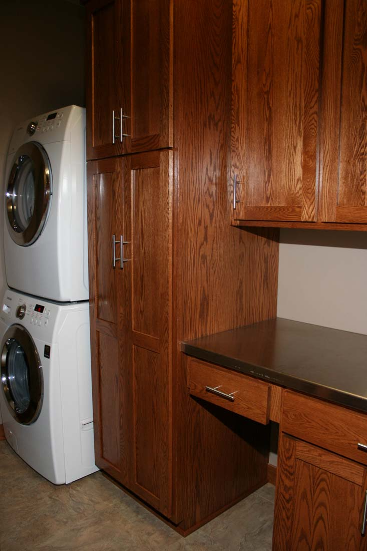 A laundry room with a washer and dryer stacked on top of each other.