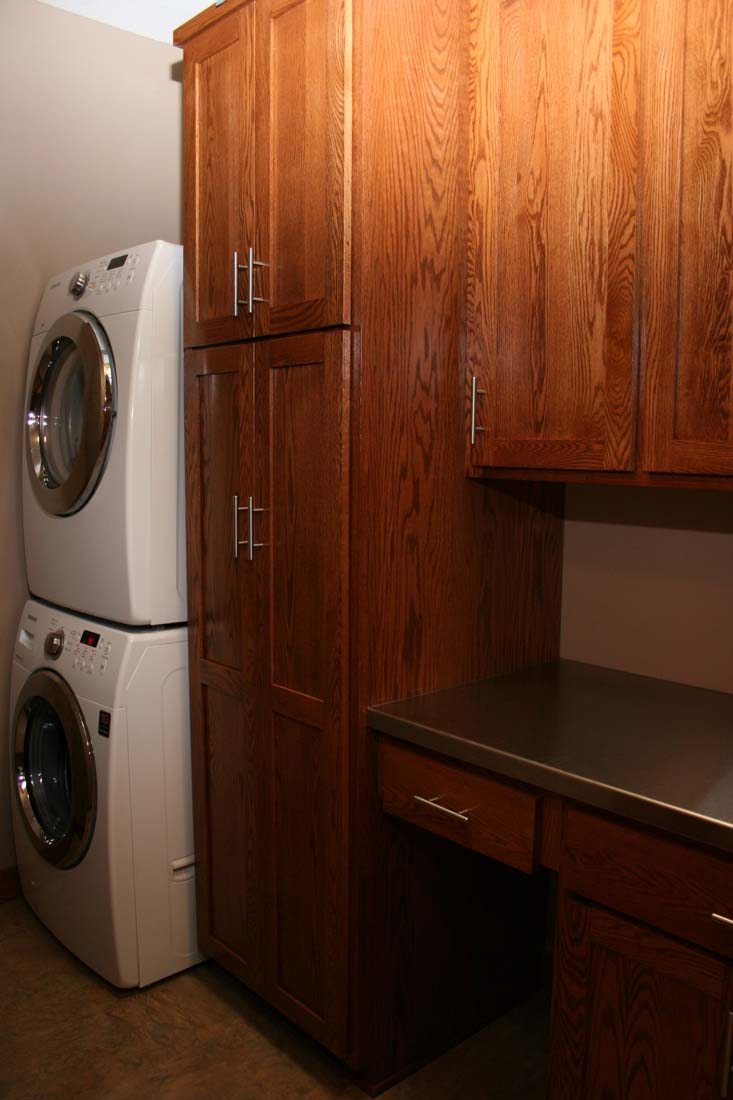 A laundry room with a washer and dryer stacked on top of each other.