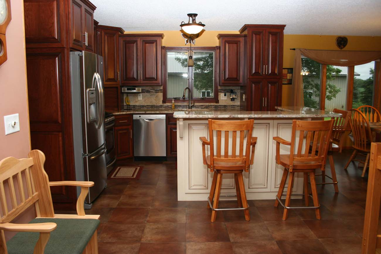 A kitchen with stainless steel appliances and wooden cabinets