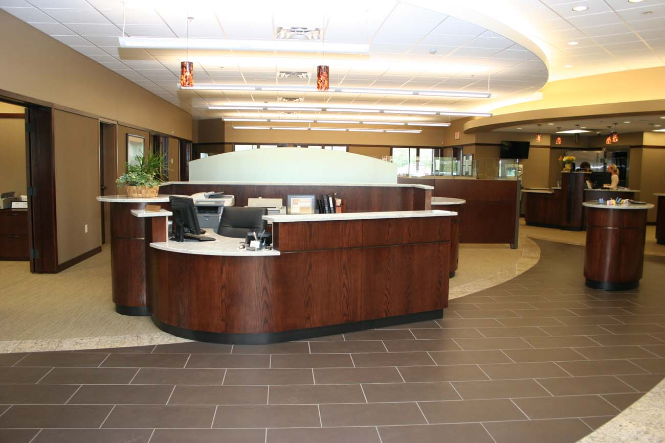 A bank lobby with a large wooden counter