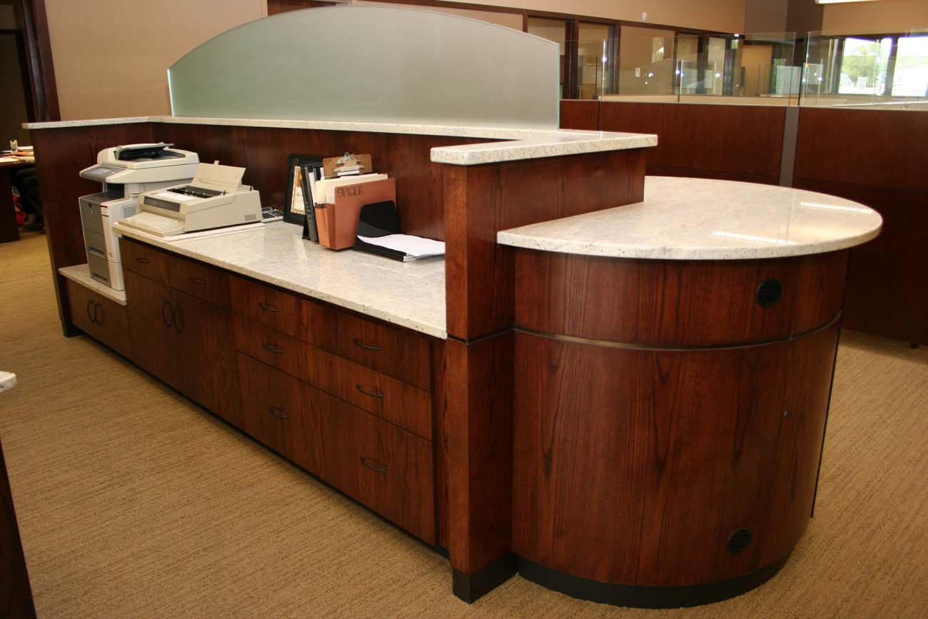 A long wooden counter with a white counter top