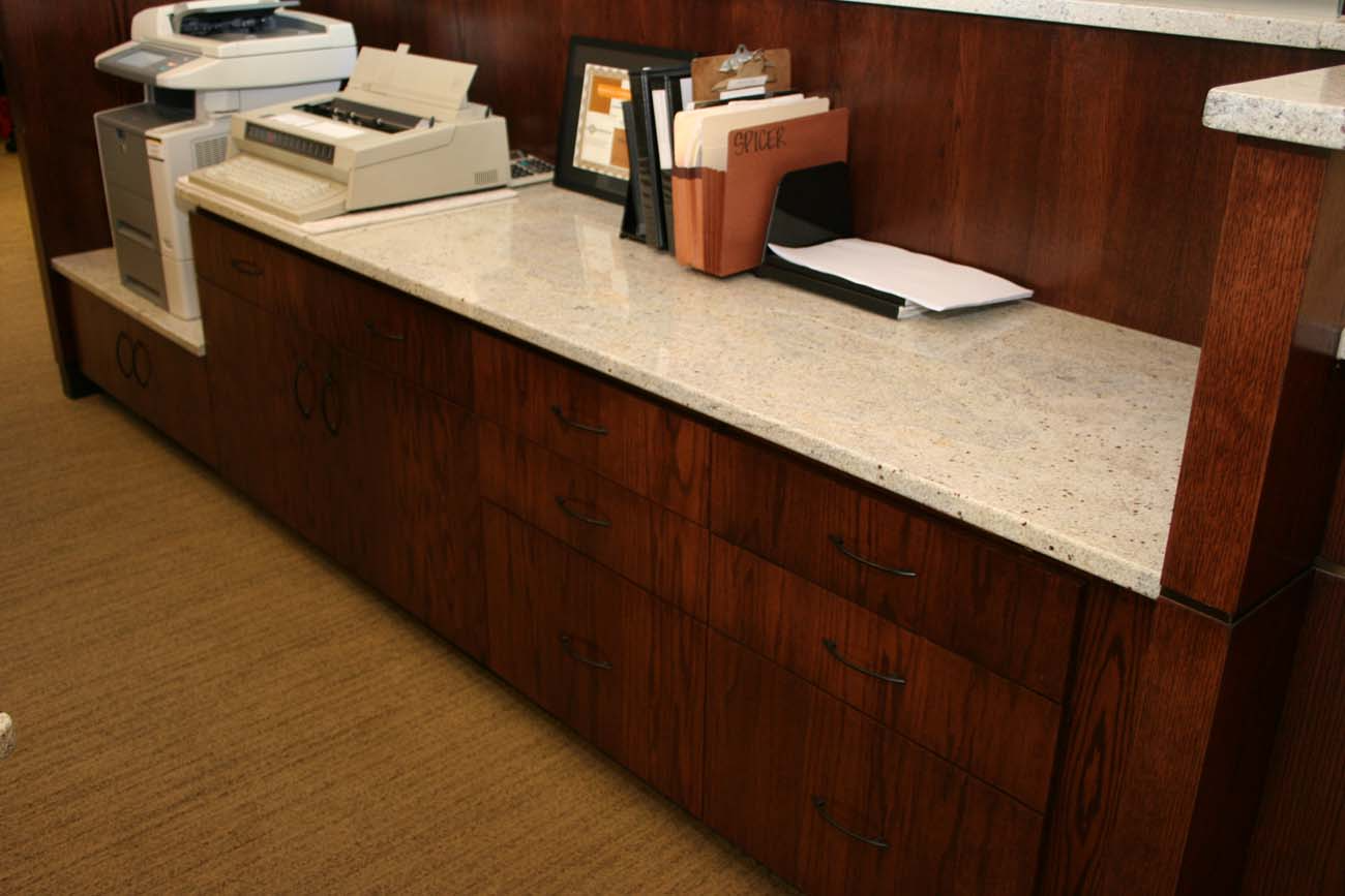 A desk with a printer and papers on it