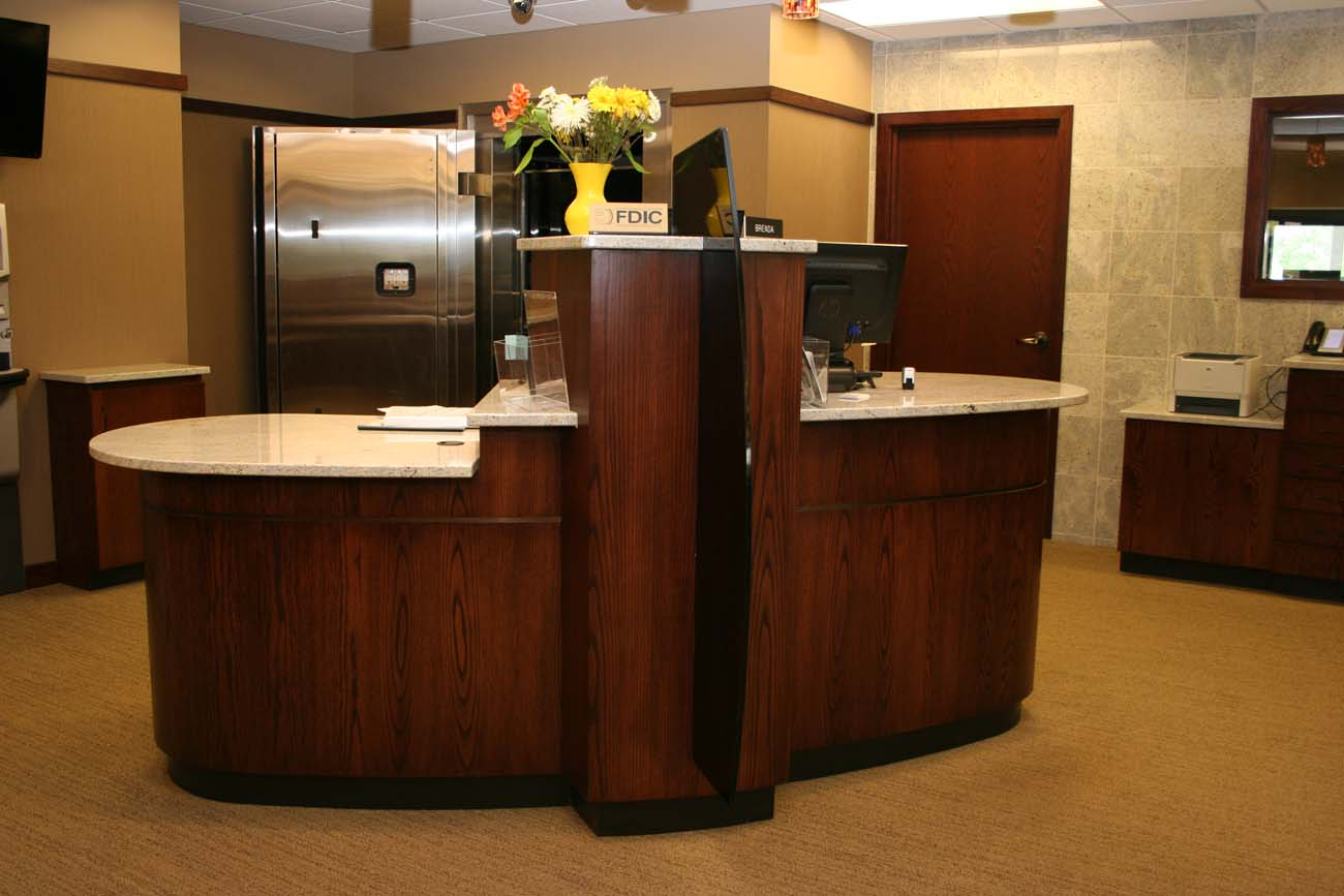 A stainless steel refrigerator is behind a wooden counter