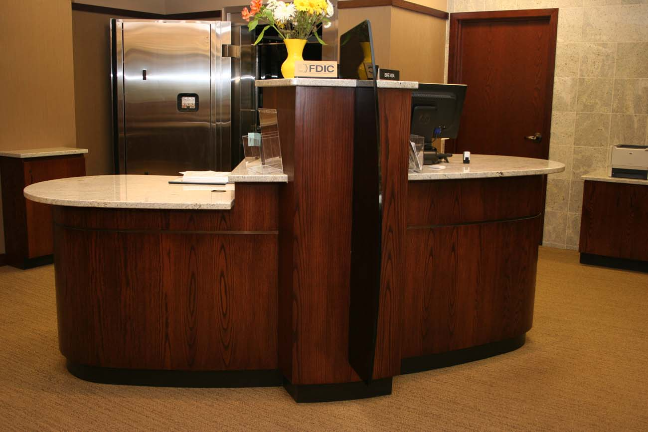 A wooden counter with a sign that says bank on it