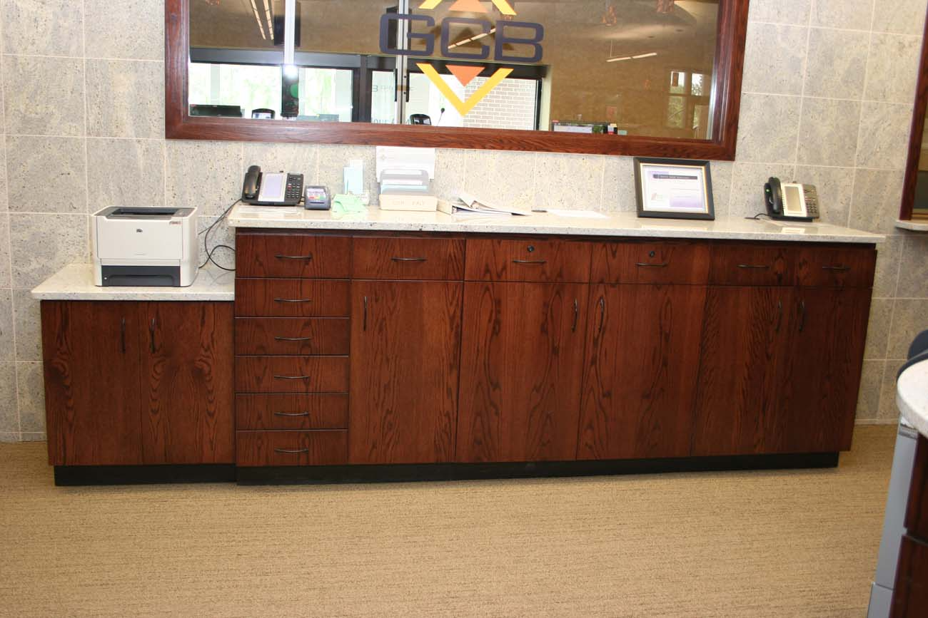 A large wooden cabinet with a printer on top of it