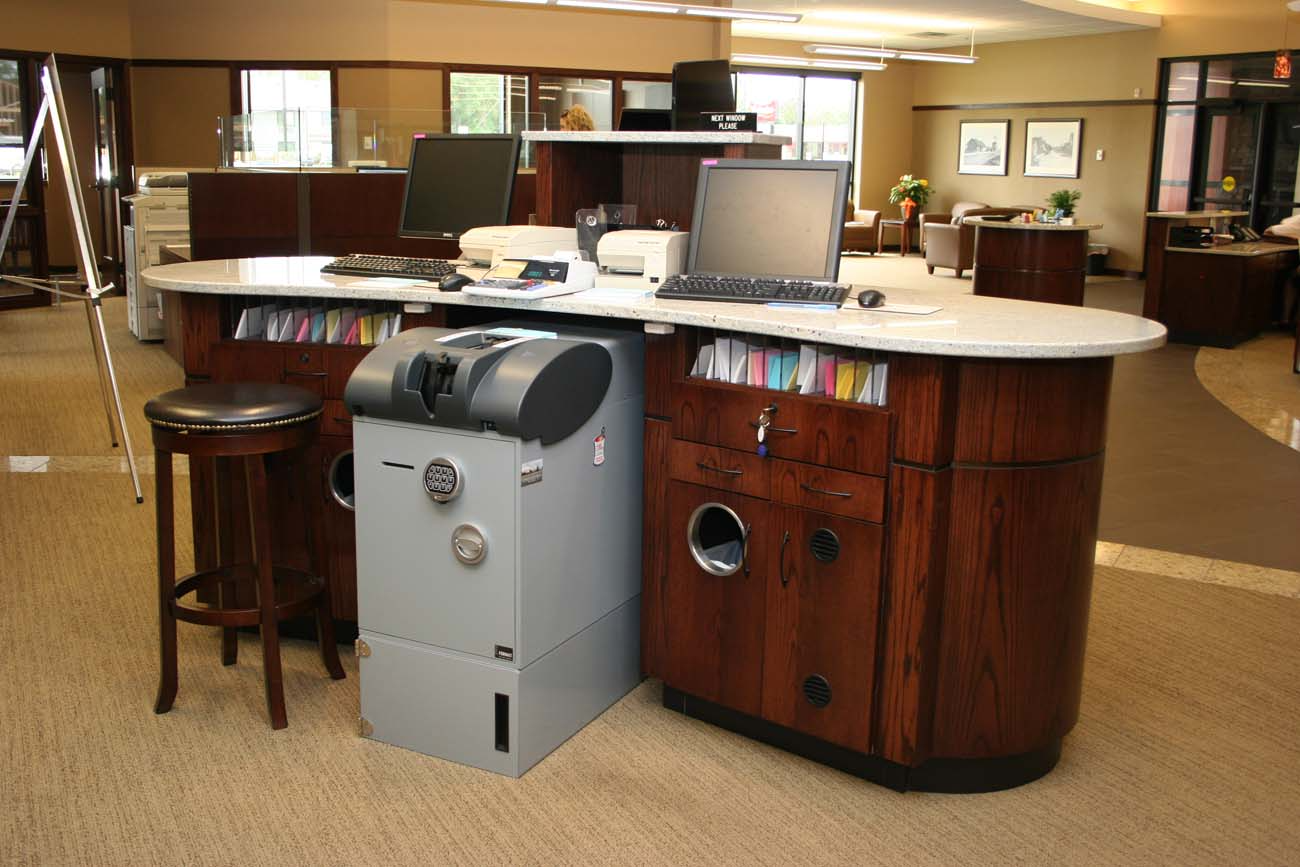 A desk with a computer and a safe on it