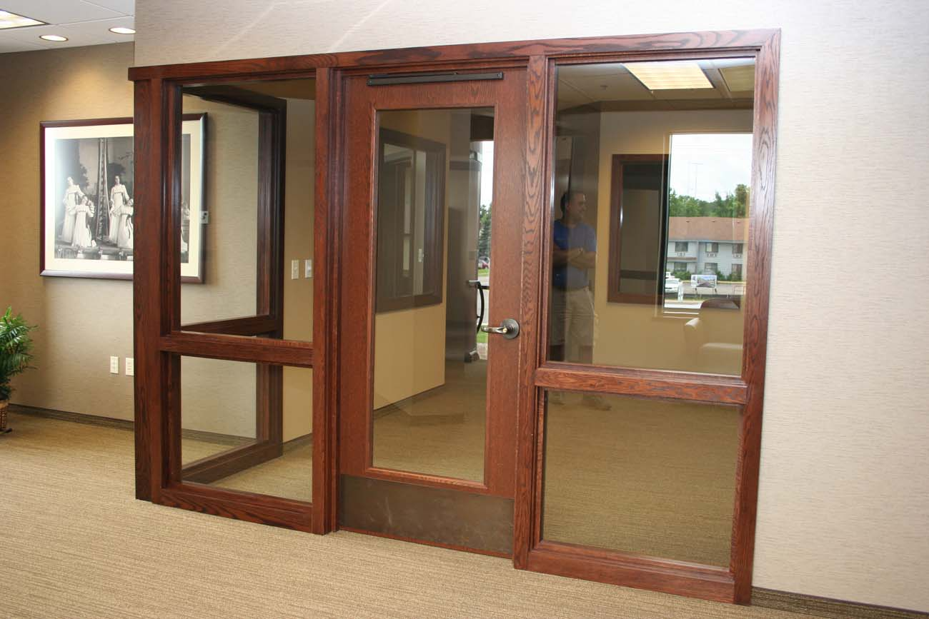 A hallway with wooden doors and a picture on the wall