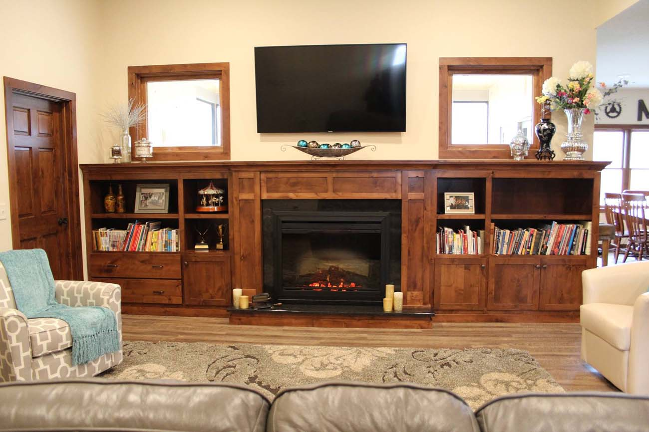 A living room with a fireplace and a flat screen tv.