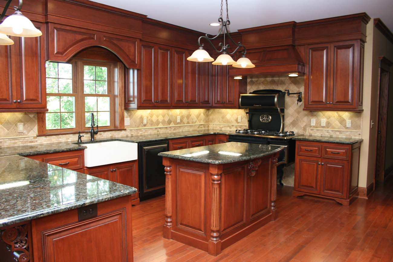 A kitchen with wooden cabinets and granite counter tops