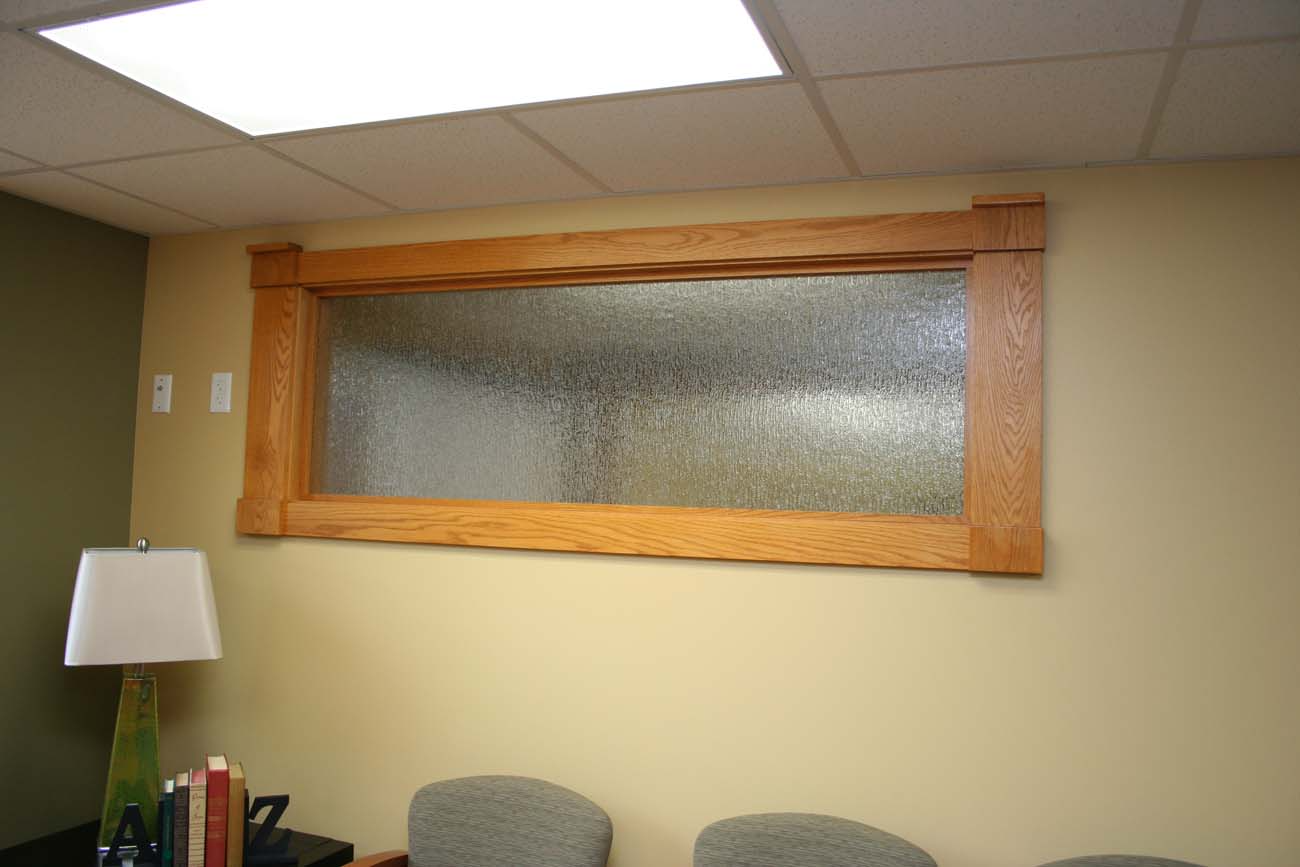 A waiting room with chairs and a large window