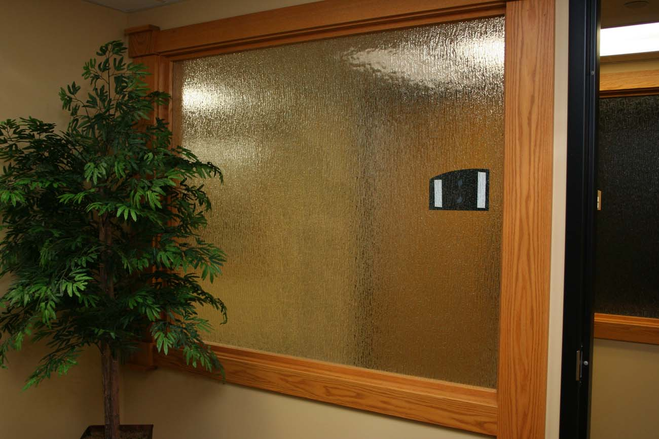 A window with a wooden frame and a plant in front of it.
