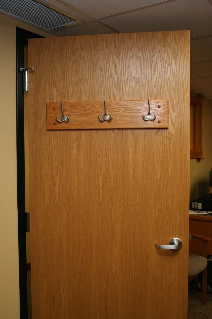 A wooden door with a coat rack on it