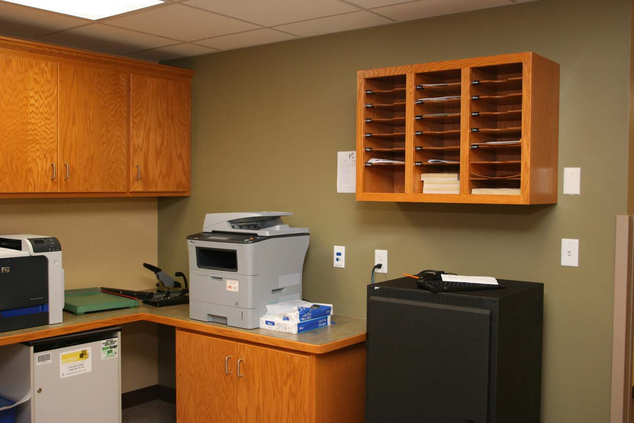 A room with a printer and a safe in it