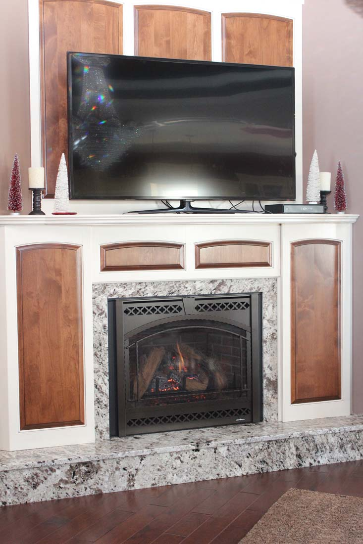A living room with a fireplace and a flat screen tv.