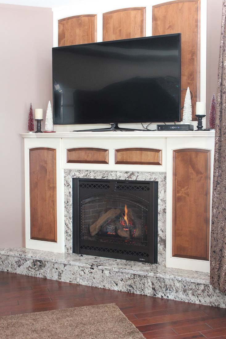 A living room with a fireplace and a flat screen tv.