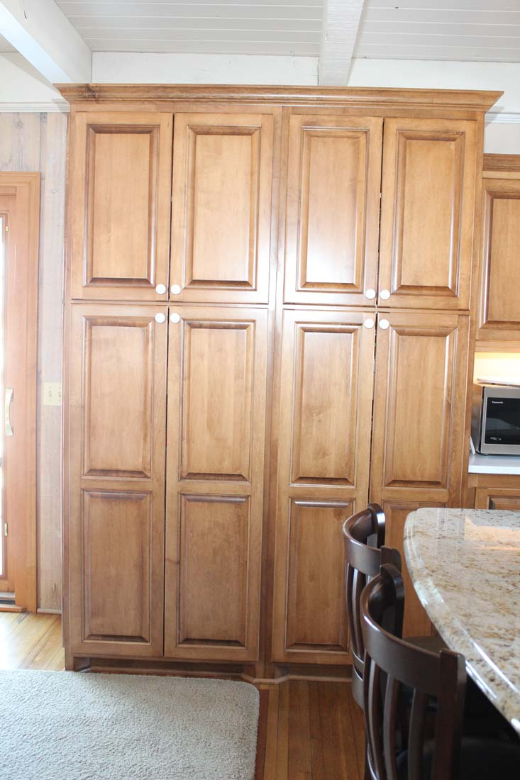A kitchen with wooden cabinets and a granite counter top