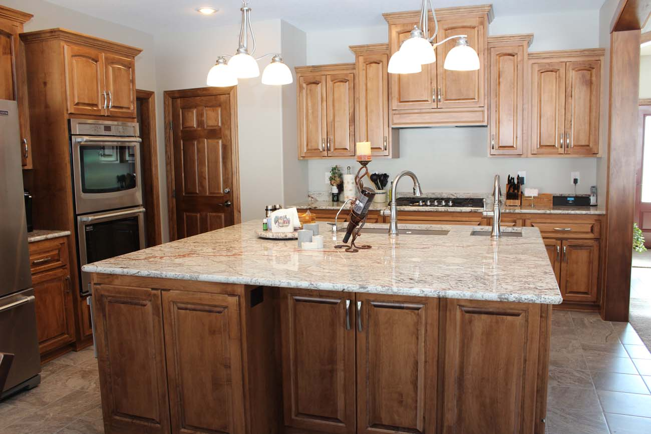 A kitchen with wooden cabinets and granite counter tops