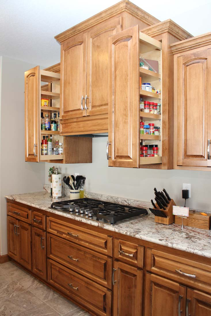 A kitchen with wooden cabinets and granite counter tops