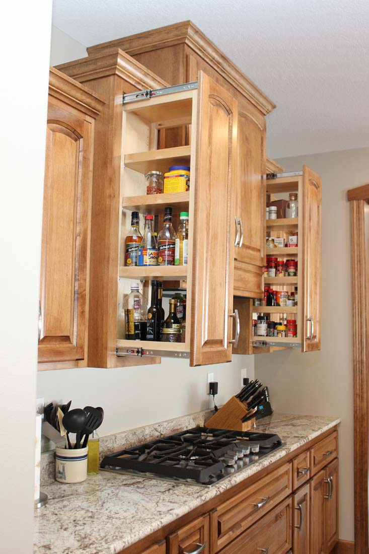 A kitchen with wooden cabinets and a stove top oven.