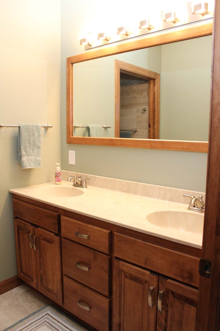 A bathroom with two sinks and a large mirror