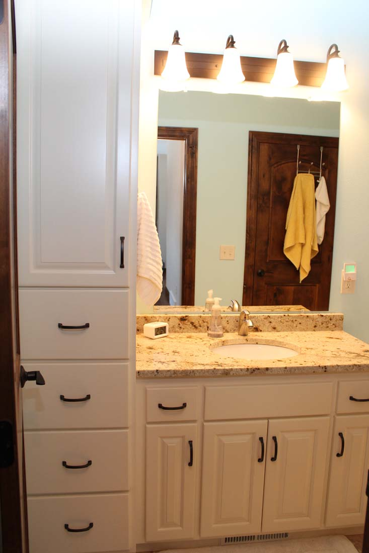 A bathroom with a sink and a large mirror