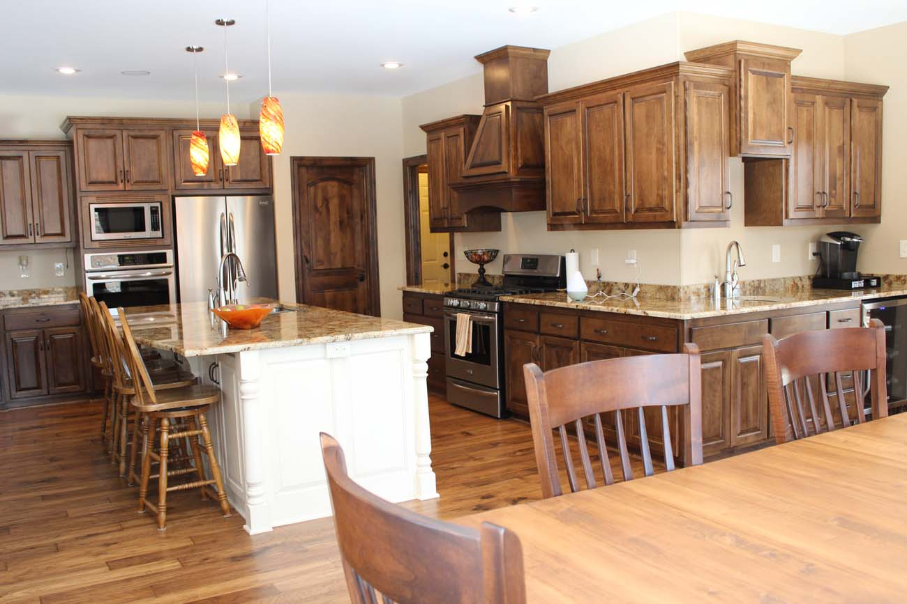 A kitchen with a table and chairs in it