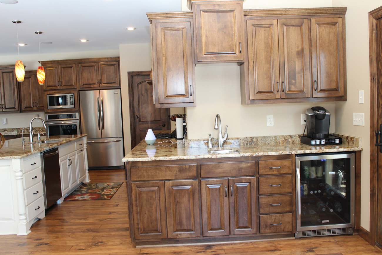 A kitchen with stainless steel appliances and wooden cabinets