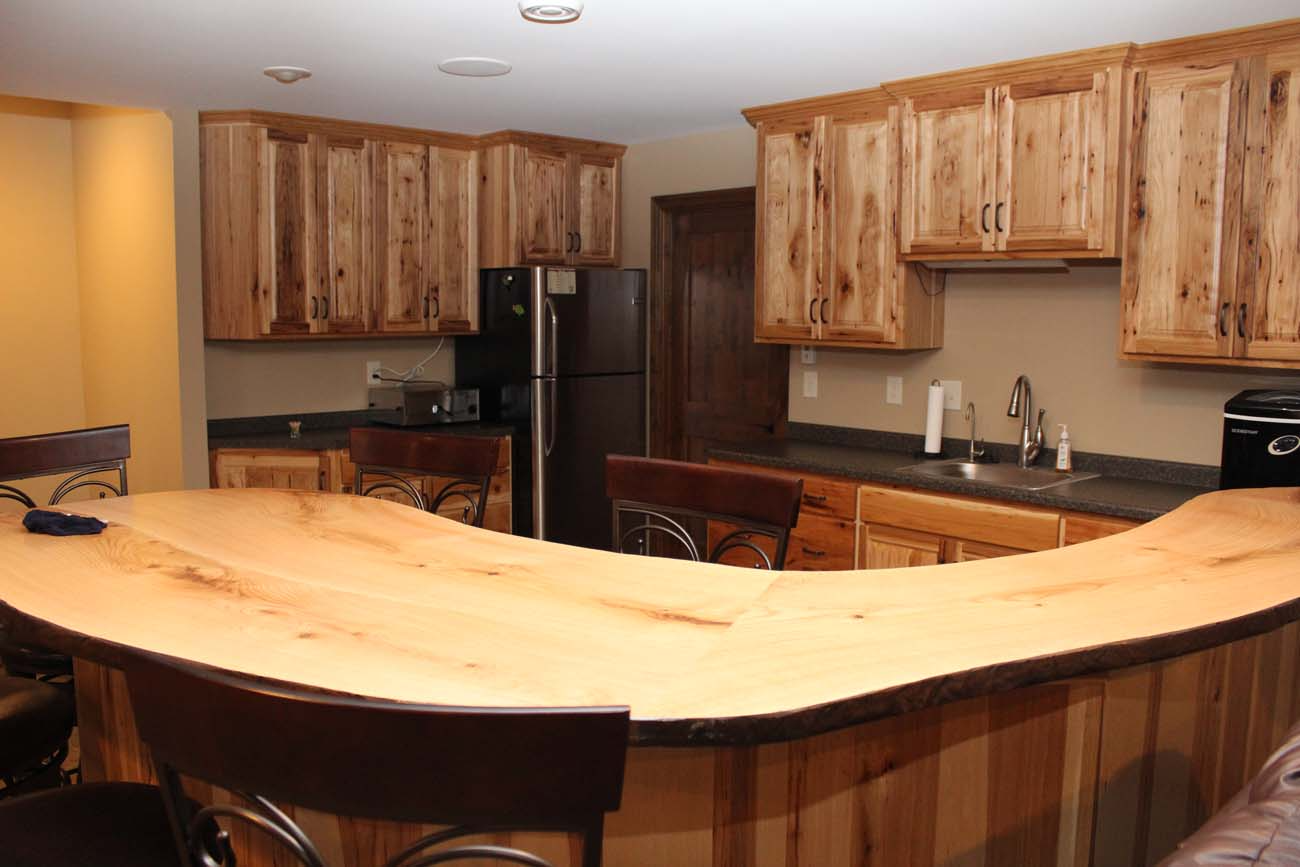 A kitchen with wooden cabinets and a wooden counter top