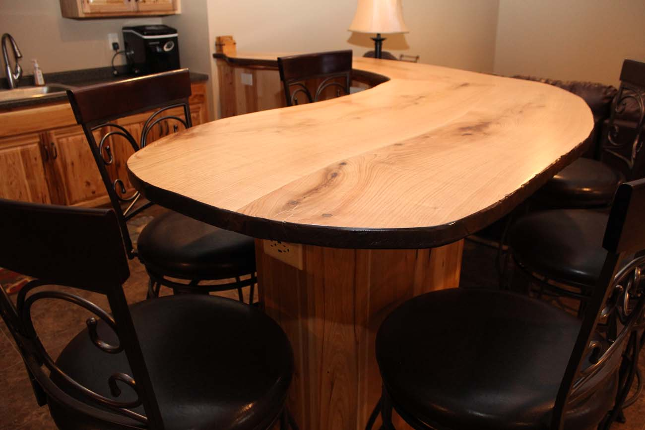 A kitchen with a wooden table and chairs