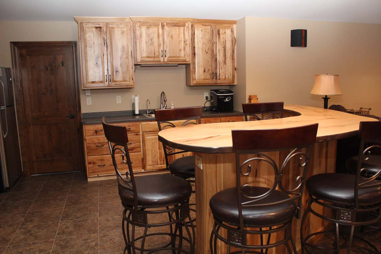 A kitchen with a wooden counter top and stools