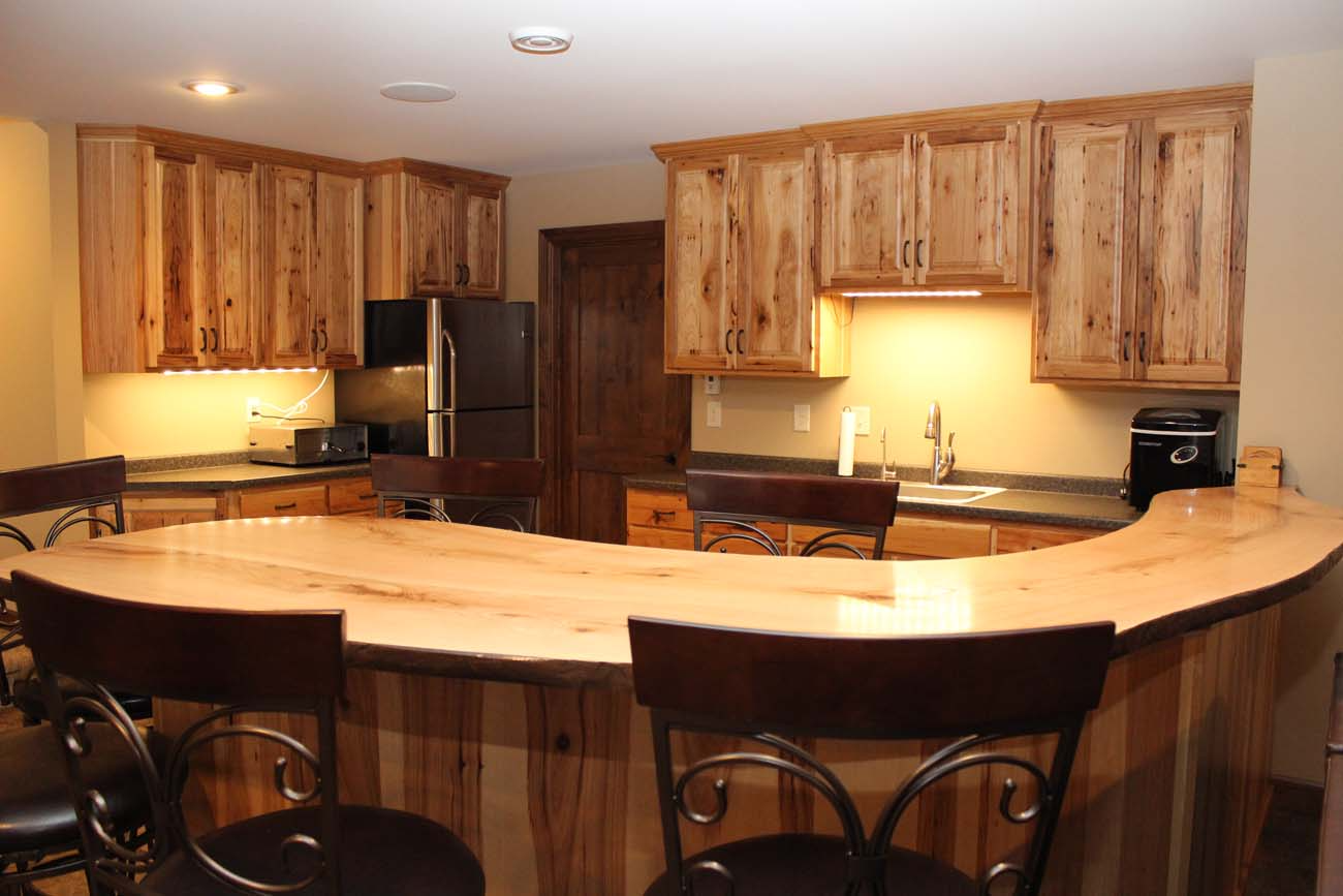 A kitchen with wooden cabinets and a curved counter top