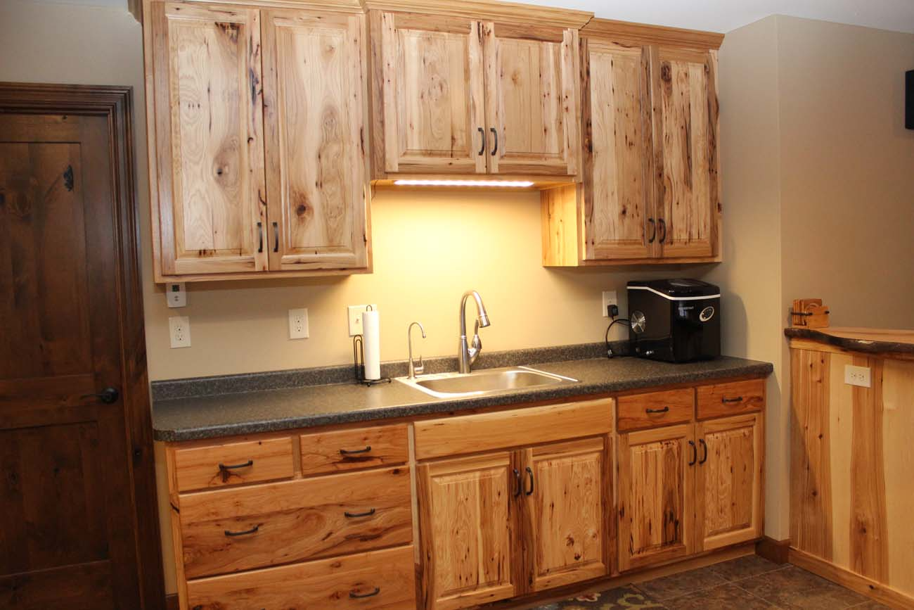 A kitchen with wooden cabinets and a sink