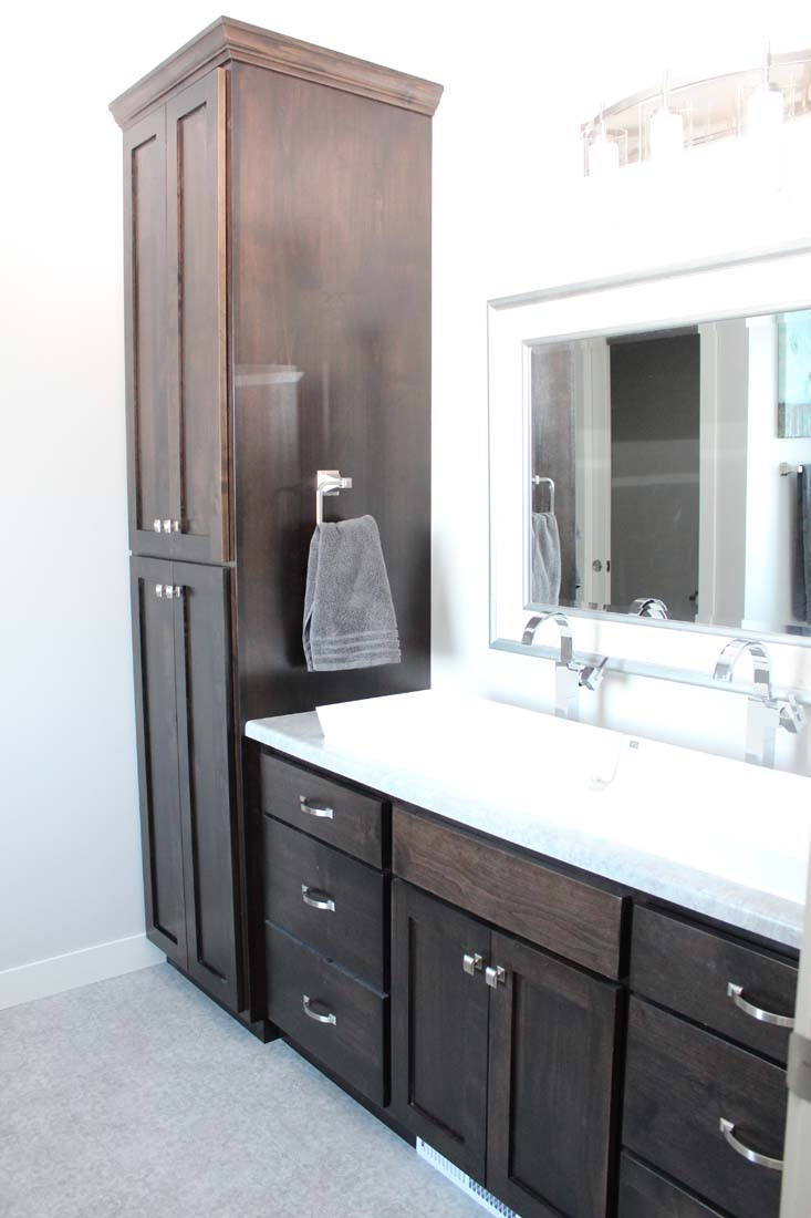 A bathroom with two sinks and a large mirror